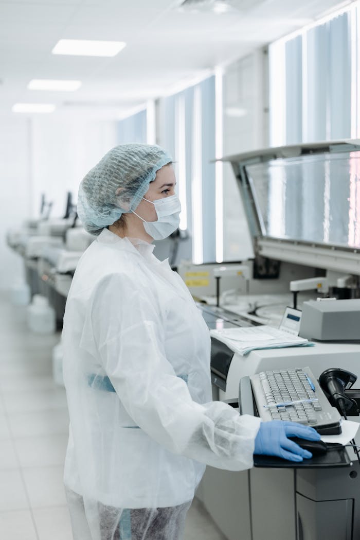 Scientist working with advanced equipment in a modern laboratory setting.